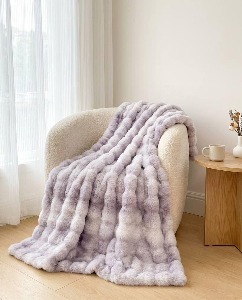 100 x 160 cm Snuglux throw in Twilight on an armchair